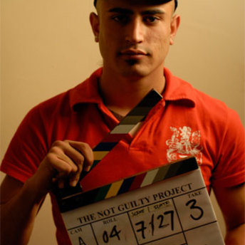 Cast member posing with clapperboard.
